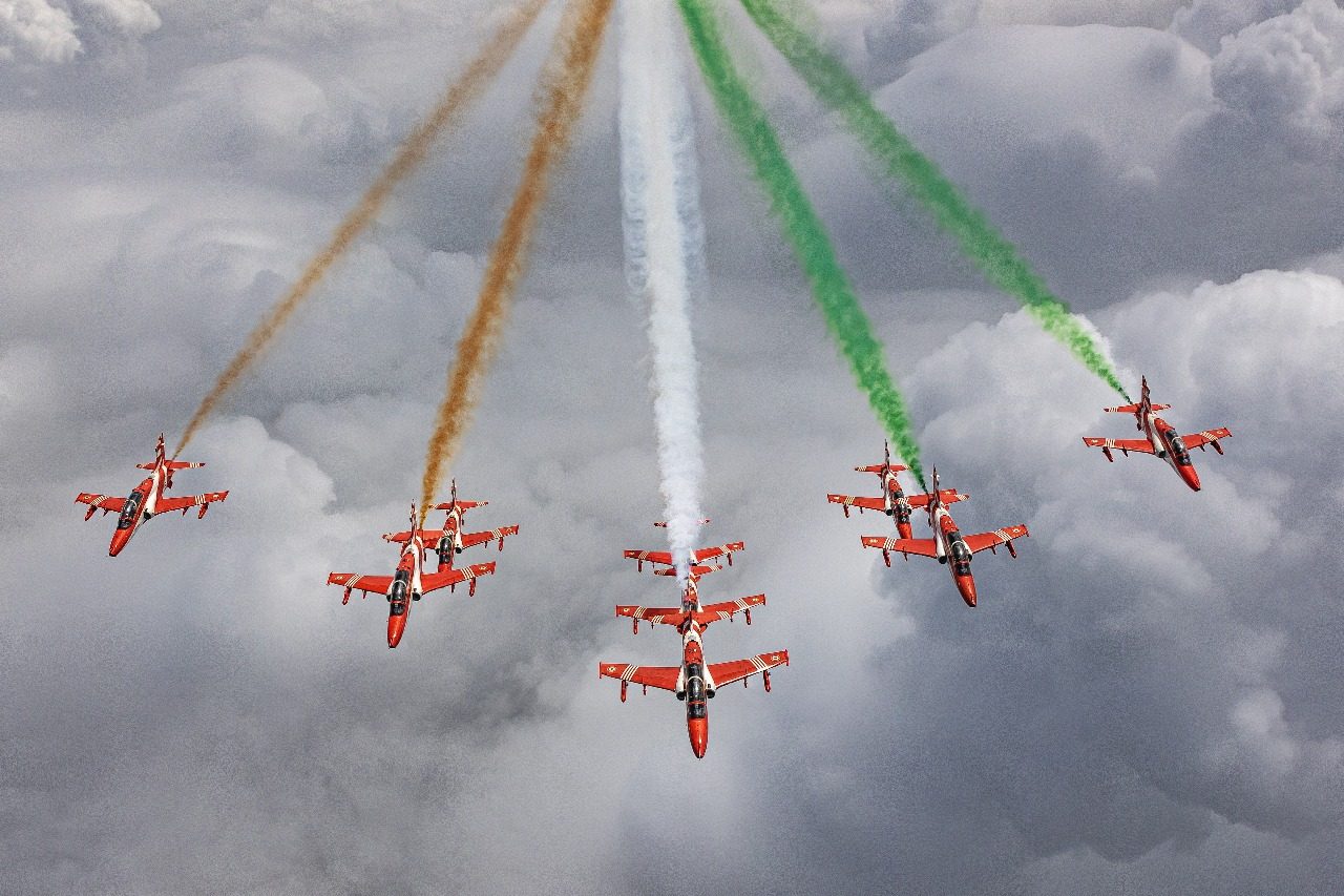 Tricolour smoke trails above the clouds